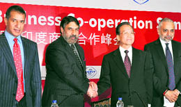 Wen Jiabao, Premier of the People's Republic of China, is greeted by Anand Sharma, Union Minister for Commerce & Industry while CII President Hari S Bhartia (R) and Ficci President Rajan Mittal (L) looks on during the India-China Business Co-operation summit in New Delhi on Wednessday