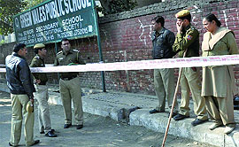 Delhi police personnel near the spot where the woman was shot at in Rohini on Wednesday.