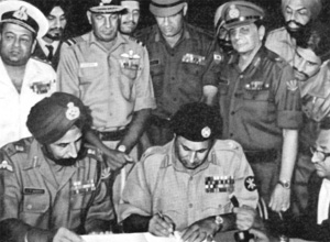 GOC-in-C, Eastern Command, Lt Gen J.S. Aurora (left) oversees his Pakstani counterpart, Lt Gen A.A.K. Niazi, signing the historic Instrument of Surrender in Dacca. Standing behind, from the left, are Flag Officer Commanding-in-Chief Eastern Naval Command, Vice Admiral N. Krishnan, Air Officer Commanding-in-Chief Eastern Air Command, Air Marshal H.C. Dewan, GOC IV Corps, Lt Gen Sagat Singh and the author, then Maj Gen J.F.R. Jacob