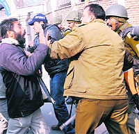 Securitymen clash with residents, who were trying to hold a procession during the curfew in Srinagar on Wednesday. 