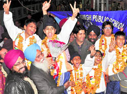 Karatekas being greeted on their arrival at the railway station in Ludhiana on Wednesday
