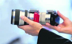 Takahiro Hirata, Category Head of Digital Imaging, Sony India, displays the company's new cameras - the NEX-5 and NEX-3 - at a press conference in Bangalore on Thursday.