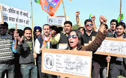 Activists of the BJYM stage a protest at Sector 33 in Chandigarh on Thursday