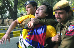Police detain Tibetan activists as they try to approach Hyderabad House , in New Delhi
