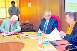 RK Arora, registrar (left) and Prof Meticarp (right) sign an MoU in the presence of HS Chahal, VC, DCRUST, Murthal