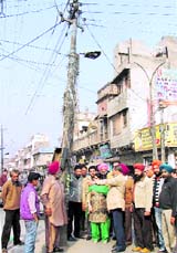 Senior Deputy Mayor Parveen Bansal along with Powercom officials inspect the location of an electricity pole at CMC Chowk in Ludhiana.