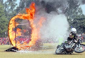 A member of the Daredevils motorcycle team from the Punjab Regimental Centre, Ramgarh Cantt, has a narrow escape while displaying his skills during an Army mela and ex-servicemens rally in Kapurthala on Thursday.