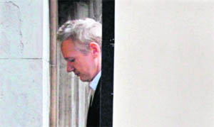 Julian Assange is led into the London high court on Thursday.