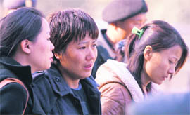 Relatives grieve as they wait for the remains oftheir kin at the Tribhuvan International Airport in Kathmandu on Thursday.