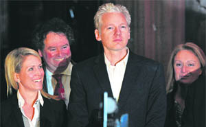 Julian Assange (centre) addresses the media in central London on Thursday.