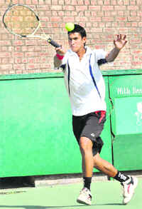 A player in action during the AITA Talent Series Tennis Tournament at Sector 10 in Chandigarh. Tribune photo: Parvesh Chauhan