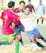 Players vie for the ball in the Shivalik Football Cup Tournament in Dehradun