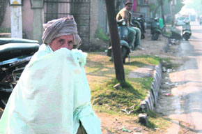 With the cold wave intensifying in the region, an old man covers himself with a shawl in Jammu. 