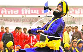 A member of a gatka group exhibits martial skills at the Jarkhar sports festival near Ludhiana on Friday.