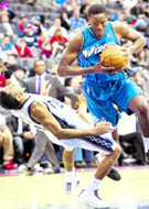 Washington Wizards Al Thorton commits an offensive foul as he drives around New Jersey Nets guard Devin Harris (L) in the fourth quarter of their NBA game in Newark, New Jersey on Thursday