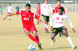 JCT (red) and East Bengal players vie for the ball in Ludhiana on Friday