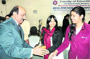 A winner being awarded at the inter-house debate competition at ICFAI University in Dehradun on Friday.