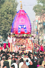 Devotees pull a chariot of Lord Jagannath during the rath yatra festival in Amritsar