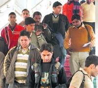 Candidates who appeared in an examination walk downstairs to catch a train from platform No. 3 at the Chandigarh railway station on Sunday.