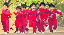 Tiny tots run to grab their Christmas gifts at Strawberry Fields in Sector 24, Chandigarh, on Sunday.
