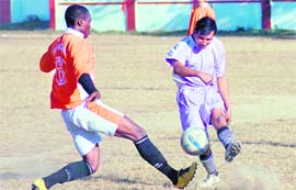 Players vie for the ball during a match of the Shivalik Football Cup Tournament in Dehradun on Sunday.