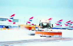 A snow plough clears the taxi ways after heavy snowfall at Heathrow Airport in London on Saturday.