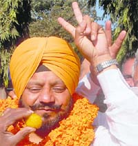 Jujhar Singh flashes a victory sign after being elected as the chairman of the Market Committee in Chandigarh on Monday