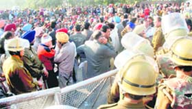 Members of the PWD Coordination Sangarsh Committee block traffic on the road separating Sectors 51 and 52 in Chandigarh on Monday.