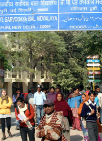 People outside GB Pant Sarvodaya Bal Vidyalaya at Sri Niwaspuri in New Delhi where a class IV student was molested, on Monday.