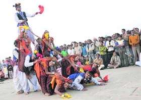 Artistes from Himachal Pradesh perform during the Gita Jayanti festival at Brahmasarovar in Kurukshetra.