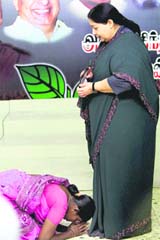 An AIADMK worker seeks blessings of party chief  J Jayalalitha at a function in Chennai on Monday.