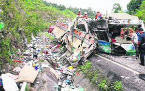 The wreckage of a bus on a highway in Pos Slim, in Malaysias northern state of Perak. The bus carrying Thai tourists hit a road divider and overturned, killing 27 persons on Monday.