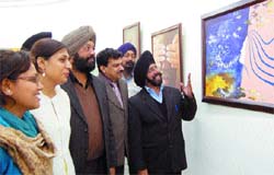 People take a look at the paintings of Panchrang artists at Thakur Singh Art Gallery in Amritsar. 