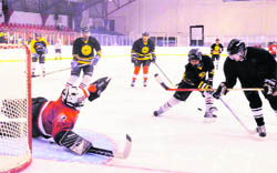 An ice-hockey match in progress at the Open Ice-Skating Championship in Dehradun on Tuesday