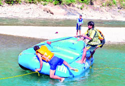 Local youth being taught river-rafting skills on the Saryu river in the Kumaon region