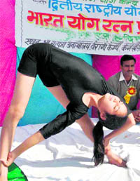 A participant performs at a yoga meet in Haridwar on Tuesday