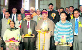 Nurpur residents who were awarded for excellence in their respective fields by an NGO, Himotukarsh, pose with their trophies. Various dignatories and members of the NGO who were present on the occasion are also seen in the picture