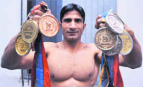 Daljit Singh shows his medals. 
