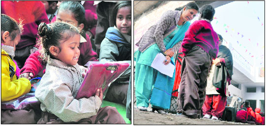 Children receive woollens distributed by volunteers of the SBI; and (right) a worker of the Santushti Educational Trust talks to an underprivileged child in Ludhiana on Tuesday. Tribune photos: Himanshu Mahajan