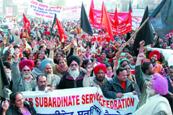 Under the banner of Punjab Subordinate Services Federation, employees of various government departments take out a protest march against non-acceptance of their demands in Bathinda on Wednesday