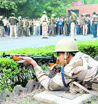 Jawans in action during a mock drill in front of the Reserve Bank of India at Sector 17 in Chandigarh 
