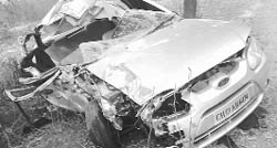 The mangled remains of the car which was hit by a bus near Desu Majra village at Kharar on Tuesday night.