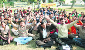 Members of the All-J&K Agriculture Daily Wagers Union hold a demonstration in Jammu on Wednesday. 