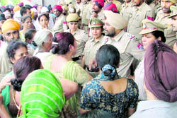 Riot victims being controlled by the police after they were protesting against the administration in Ludhiana