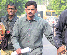 Policemen take Surinder Koli to jail from a special CBI court in Ghaziabad on Wednesday after he was sentenced to death by the court. 
