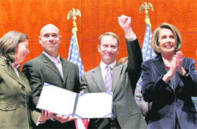 GAYS ARE WELCOME IN US ARMY: Speaker Nancy Pelosi (right) applauds as former service members hold the signed Bill to repeal 'Don't Ask Don't Tell', during an enrolment ceremony on Capitol Hill in Washington on Tuesday.