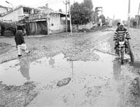 A view of potholed roads of Rajpura. 