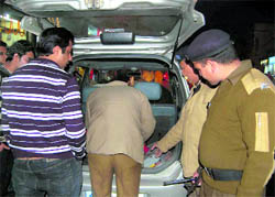 Policemen check a vehicle on the New Years Eve in Dehradun on Friday