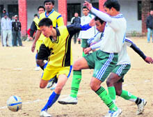 Players vie for the ball during a match of the Shaheed Khadag Bahadur Memorial Football Tournament in Dehradun on Friday