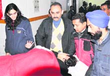 Himani Verma being consoled at the Mela Hospital in Haridwar on Friday. 